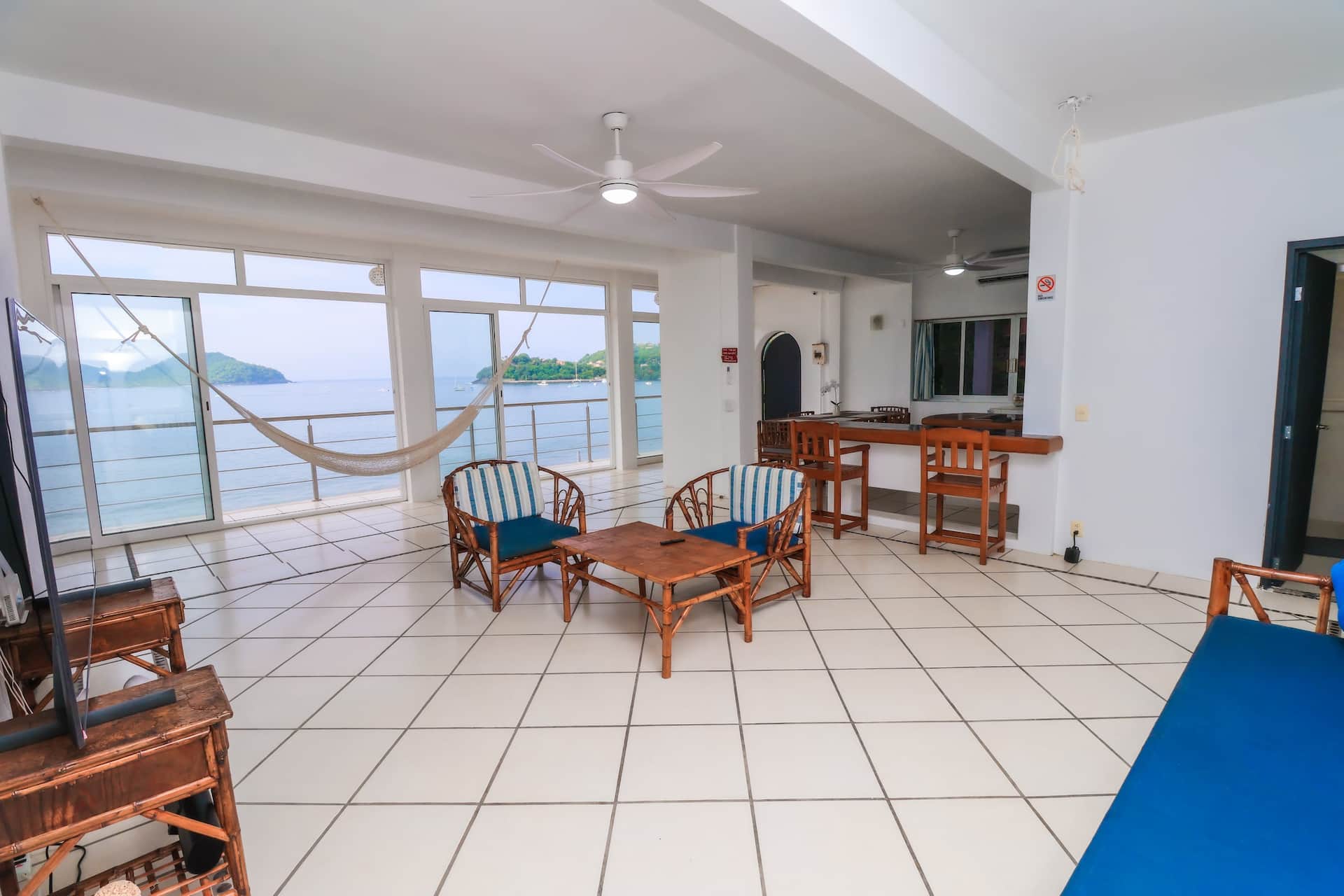 Oasis: open living room with a hammock and the sea beyond